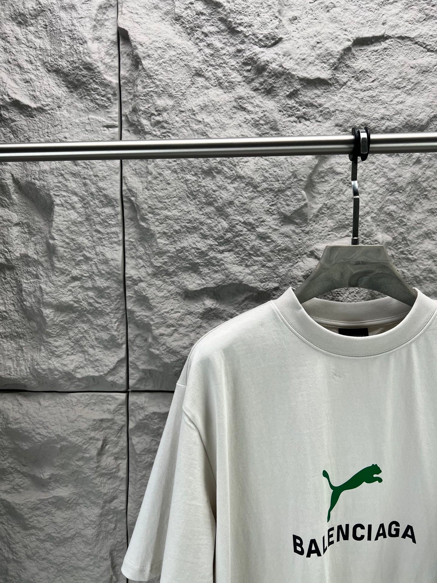 Light gray short-sleeve T-shirt front close-up with green Balenciaga logo