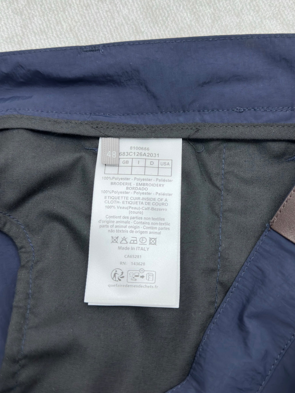 Dior pants interior care label on dark lining with blue outer fabric