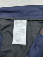 Dior pants interior care label on dark lining with blue outer fabric