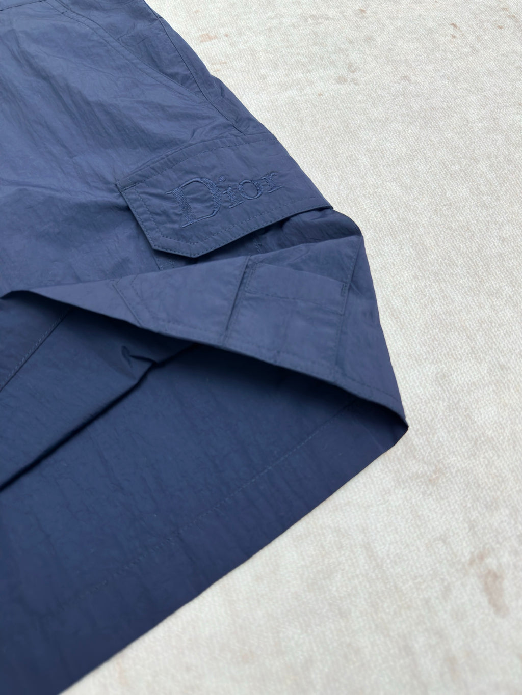 Dior blue short pants with diagonal pocket flap and stitched panels
