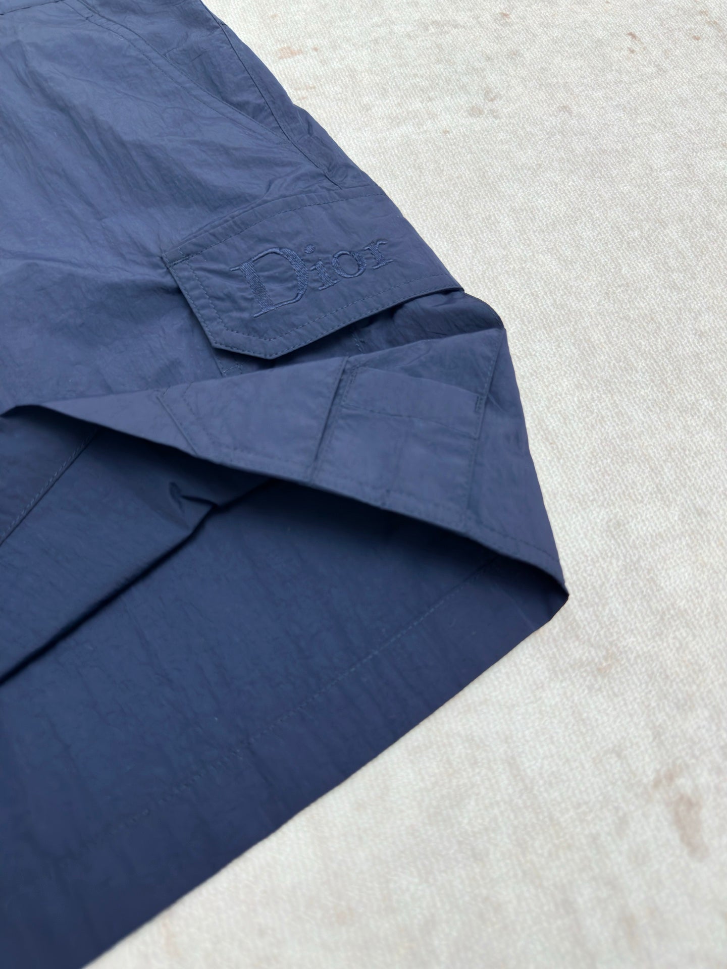 Dior blue short pants with diagonal pocket flap and stitched panels