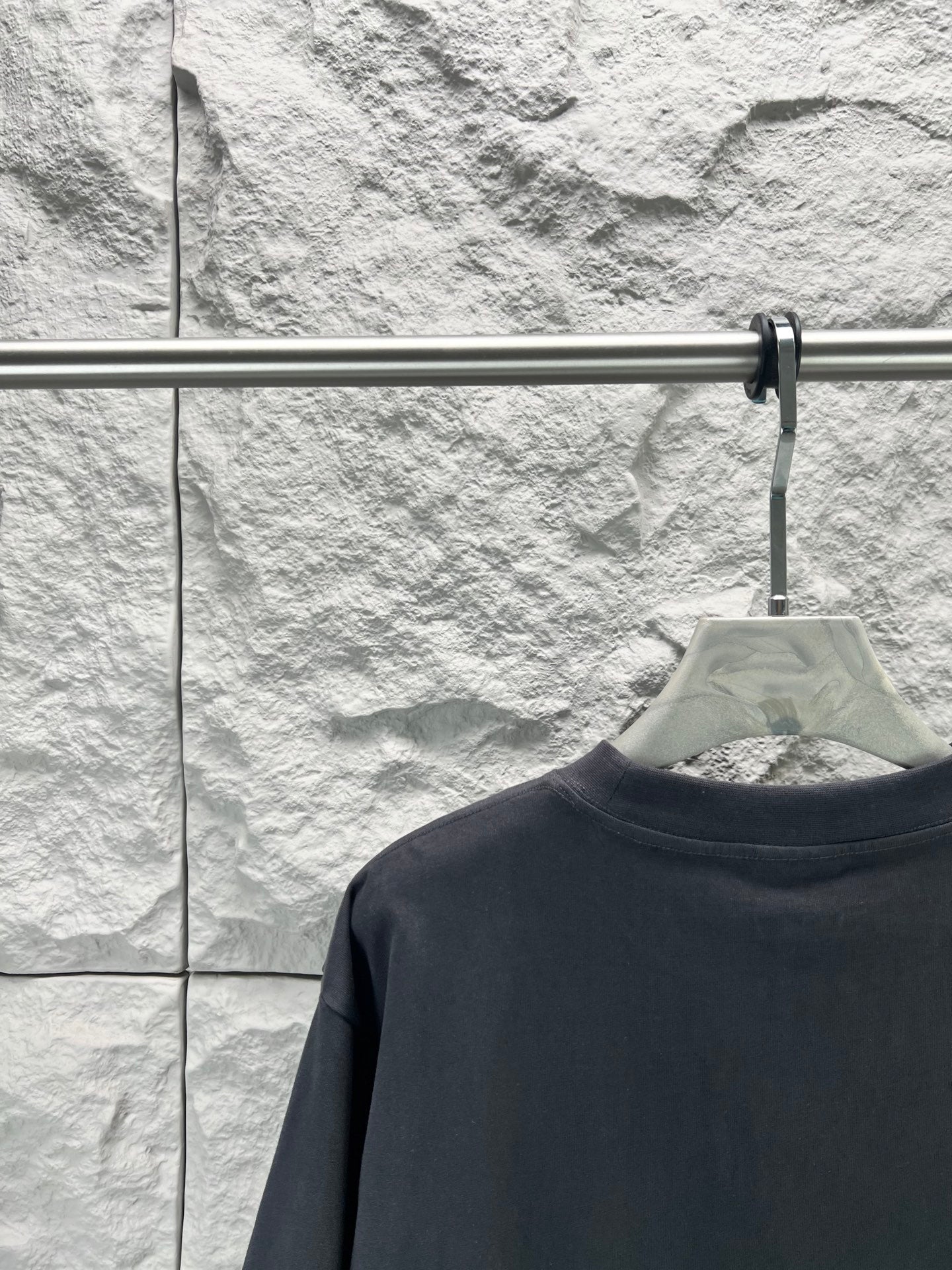 Balenciaga dark navy T-shirt back view, crew neck on hanger