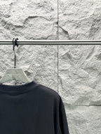 Balenciaga dark navy T-shirt back view, collar area on hanger