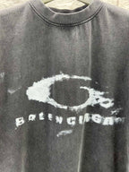 Dark short-sleeve T-shirt close-up of distressed oval and BALENCIAGA print