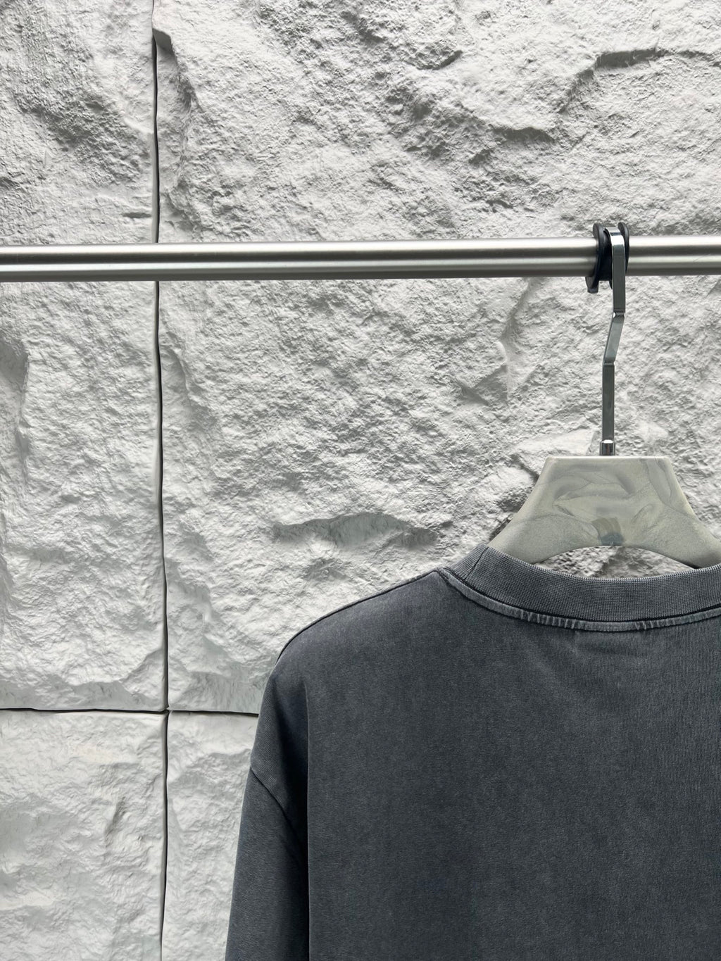 Dark short-sleeve T-shirt close-up of collar and plain back panel