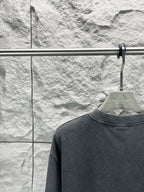 Dark short-sleeve T-shirt close-up of collar and plain back panel