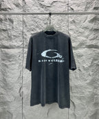 Dark short-sleeve T-shirt with large distressed oval logo graphic at center