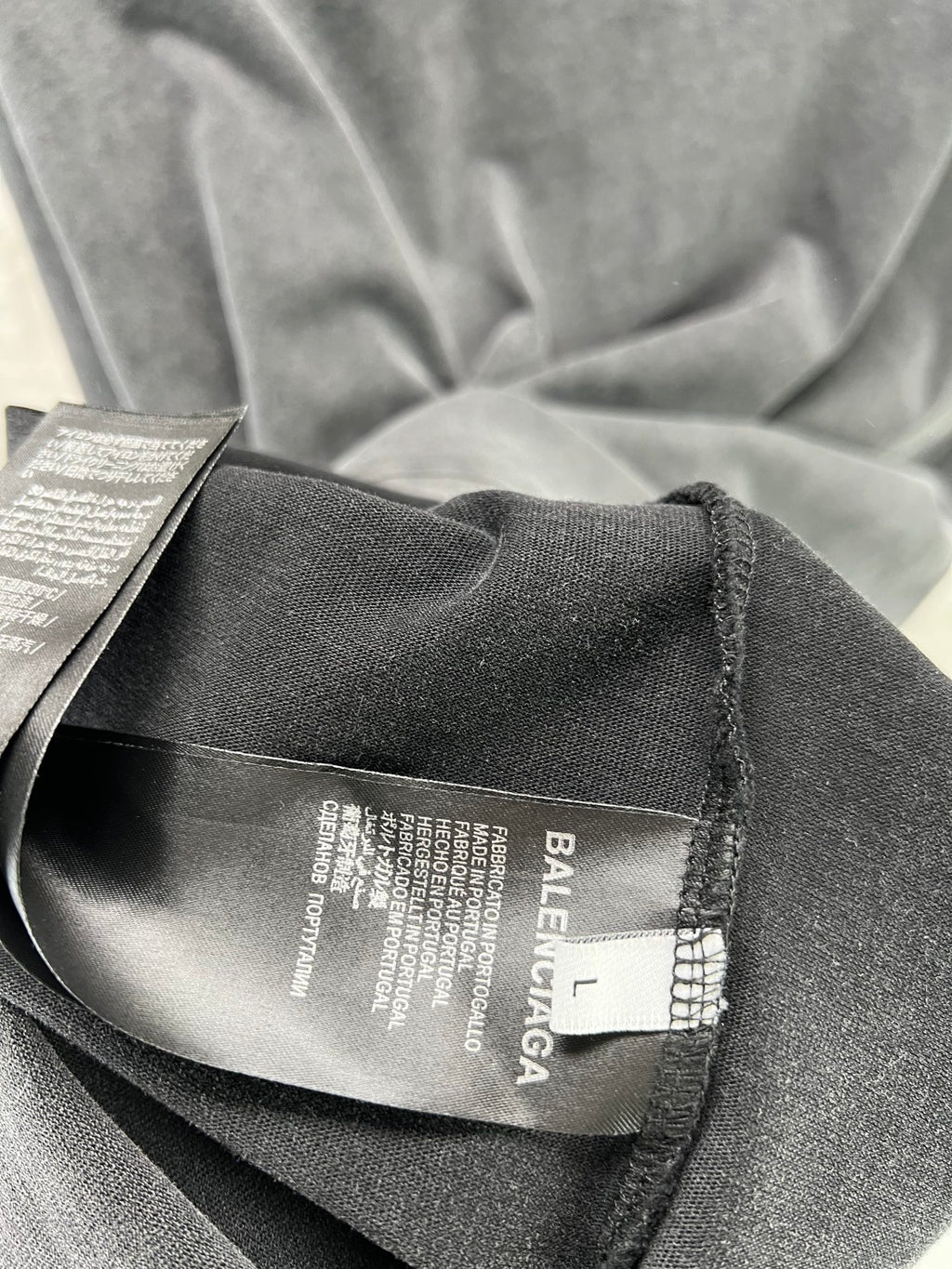Dark T-shirt interior neck tag and woven fabric close-up