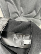 Dark T-shirt interior neck tag and woven fabric close-up