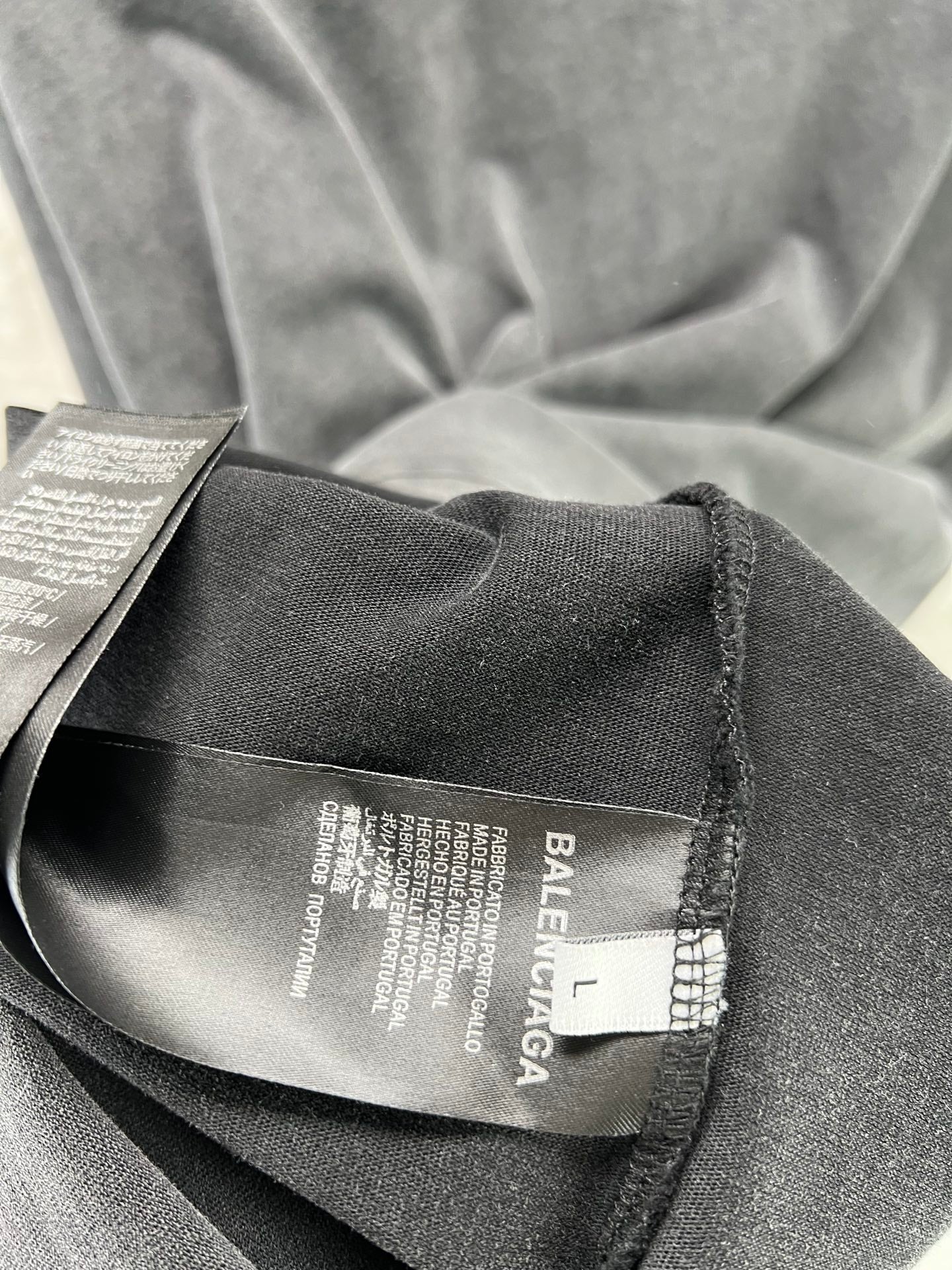Dark T-shirt interior neck tag and woven fabric close-up