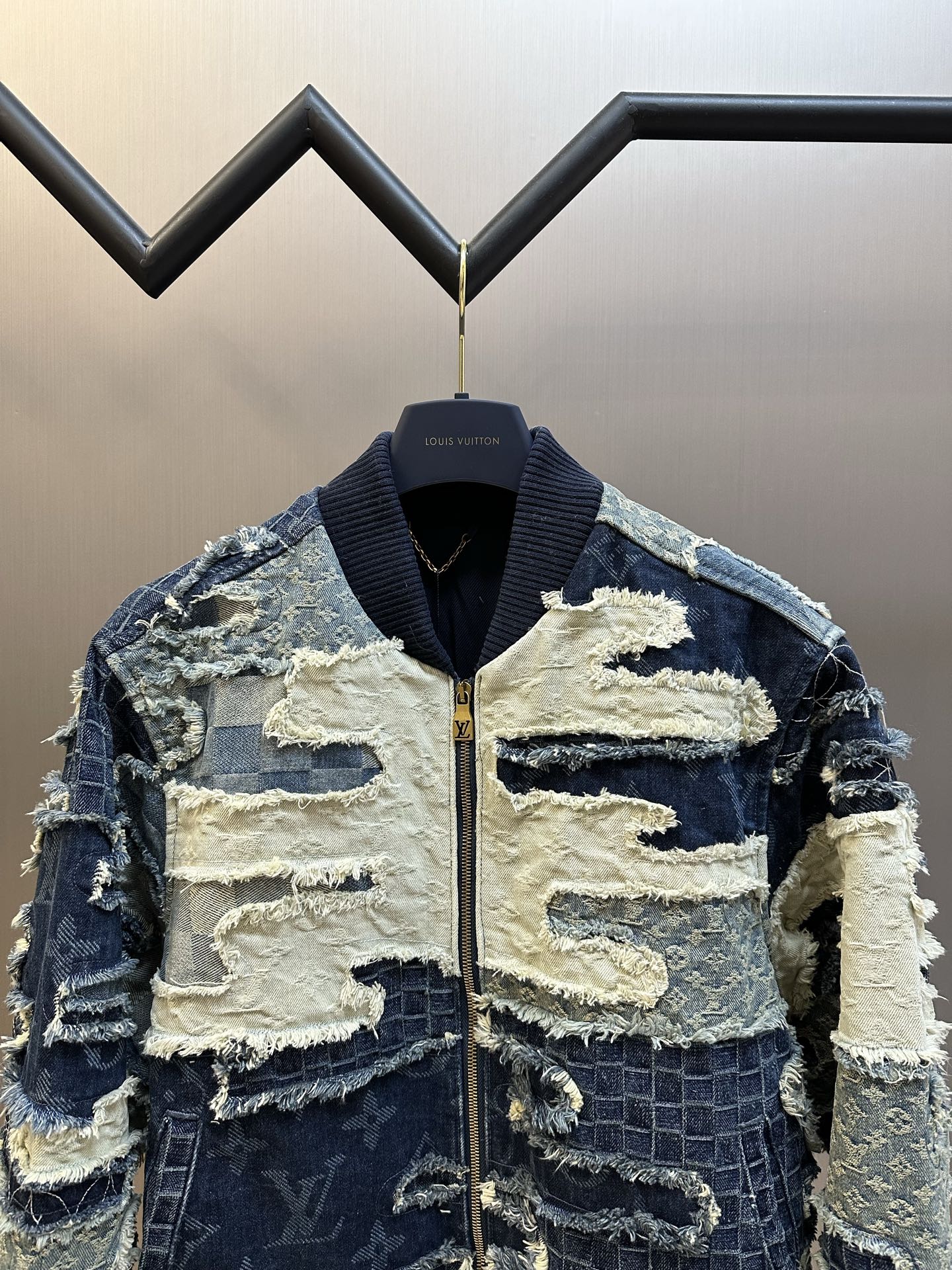 Patchwork denim jacket with stand collar and front zipper, blue-and-cream textured panels