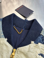 Denim jacket with knit ribbed collar, front zipper, and inner neck label with chain loop
