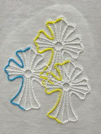 Close-up of multicolor floral embroidery on white T-shirt fabric