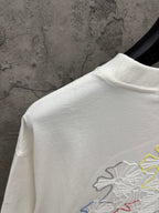 White T-shirt shoulder and upper back with partial multicolor floral embroidery