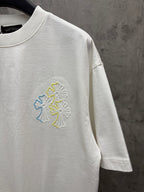 White short-sleeve T-shirt with small multicolor floral embroidery on chest