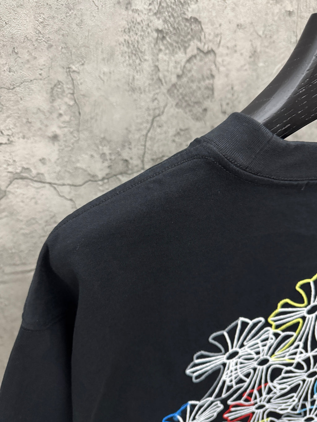 Dark navy short-sleeve T-shirt with multicolor floral line embroidery on back shoulder