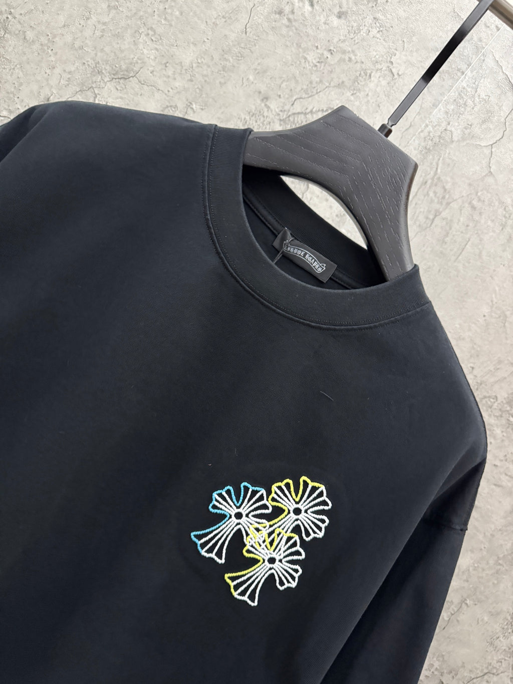 Dark navy short-sleeve T-shirt neckline and chest logo with small multicolor floral embroidery