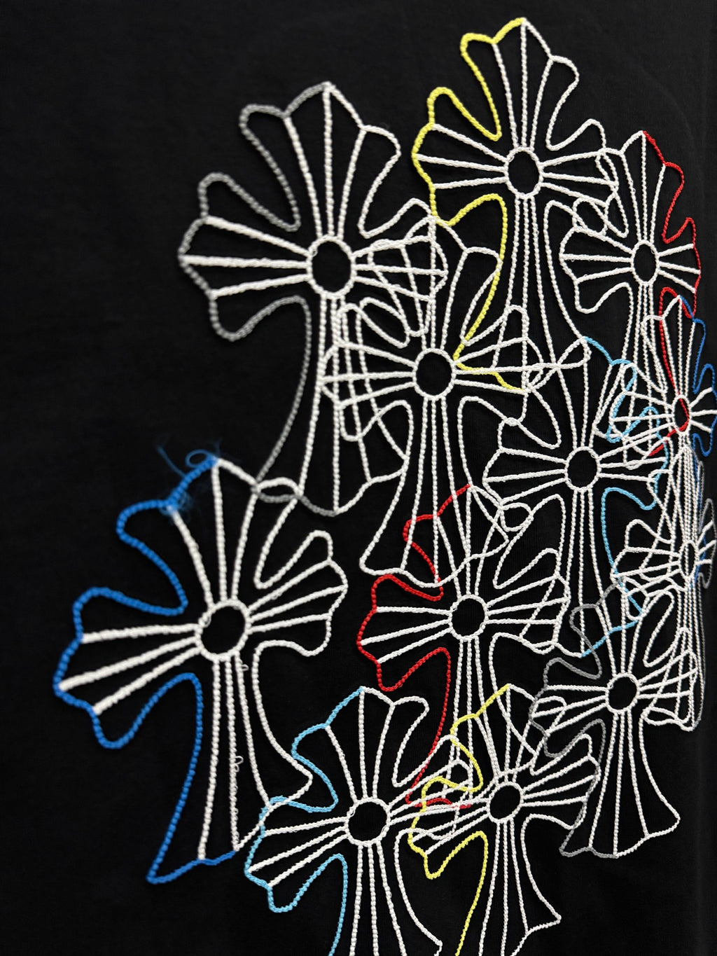 Large multicolor floral line embroidery on back of dark navy short-sleeve T-shirt