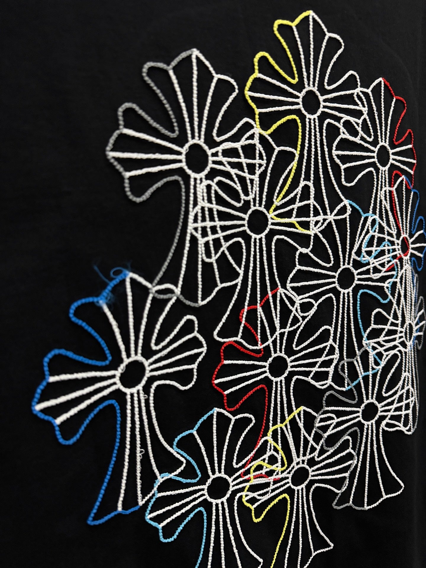 Large multicolor floral line embroidery on back of dark navy short-sleeve T-shirt