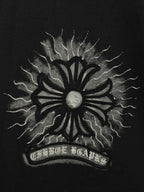 Black T-shirt close-up of large sunburst emblem with lightning rays and halo center