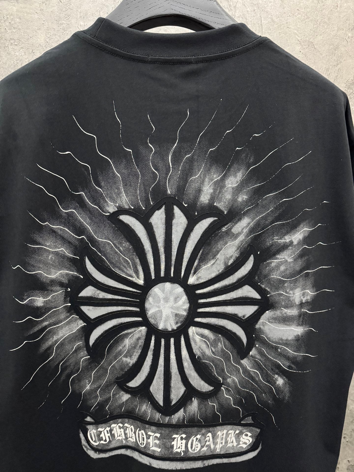 Black short-sleeve T-shirt with full back sunburst flower graphic and lightning lines