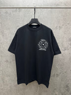 Black short-sleeve T-shirt with small sunburst graphic and lightning print on chest