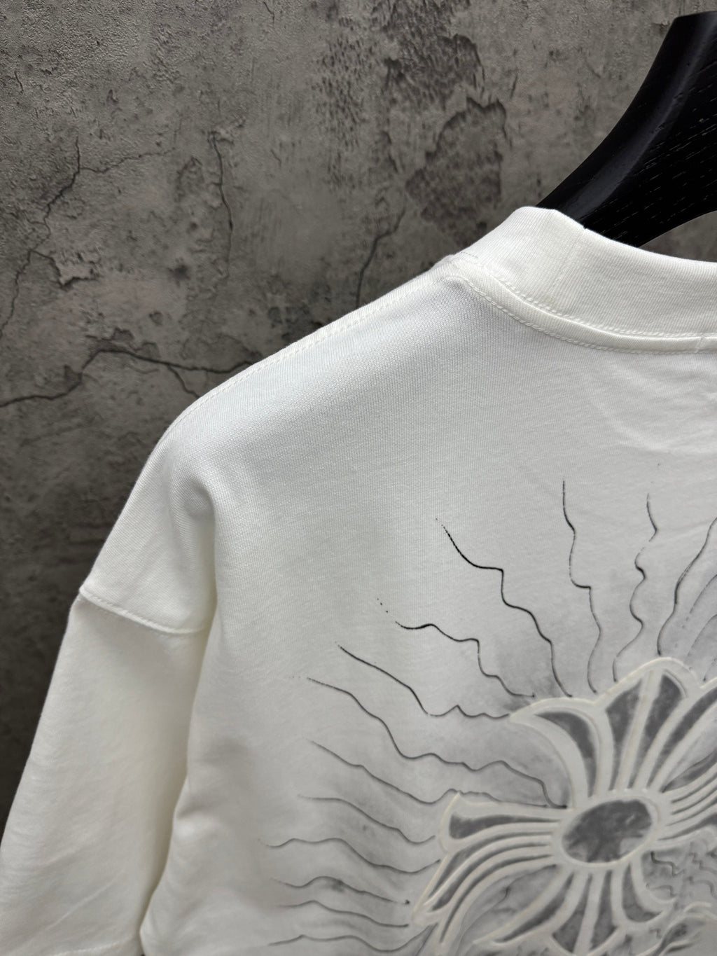 White short-sleeve T-shirt back close-up of sunburst floral print