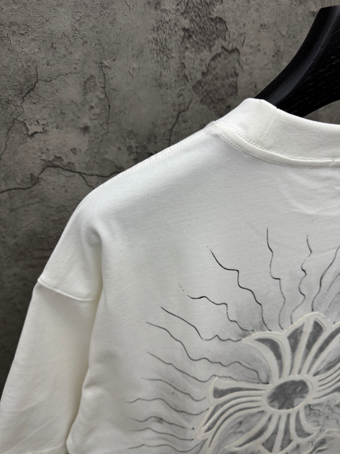 White short-sleeve T-shirt back close-up of sunburst floral print