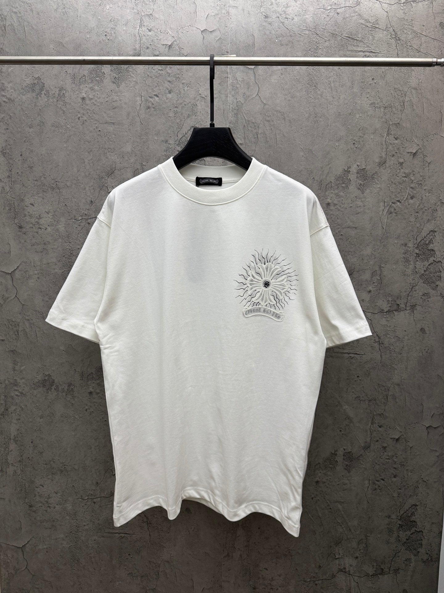 White short-sleeve T-shirt with small chest sunburst floral graphic