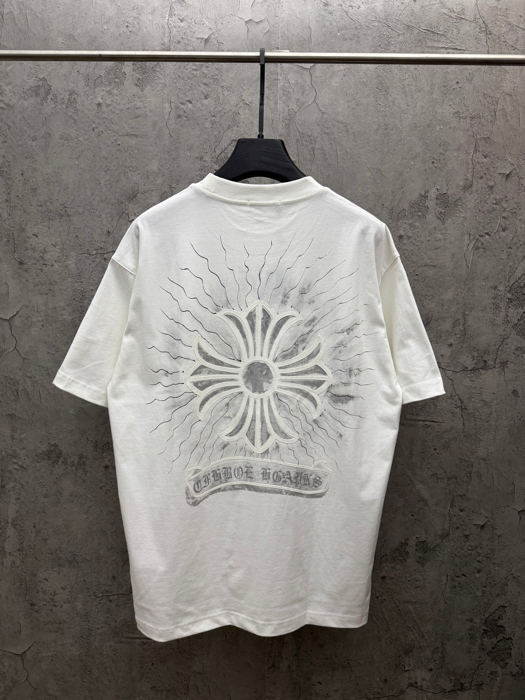 White short-sleeve T-shirt with large back sunburst floral print and banner text