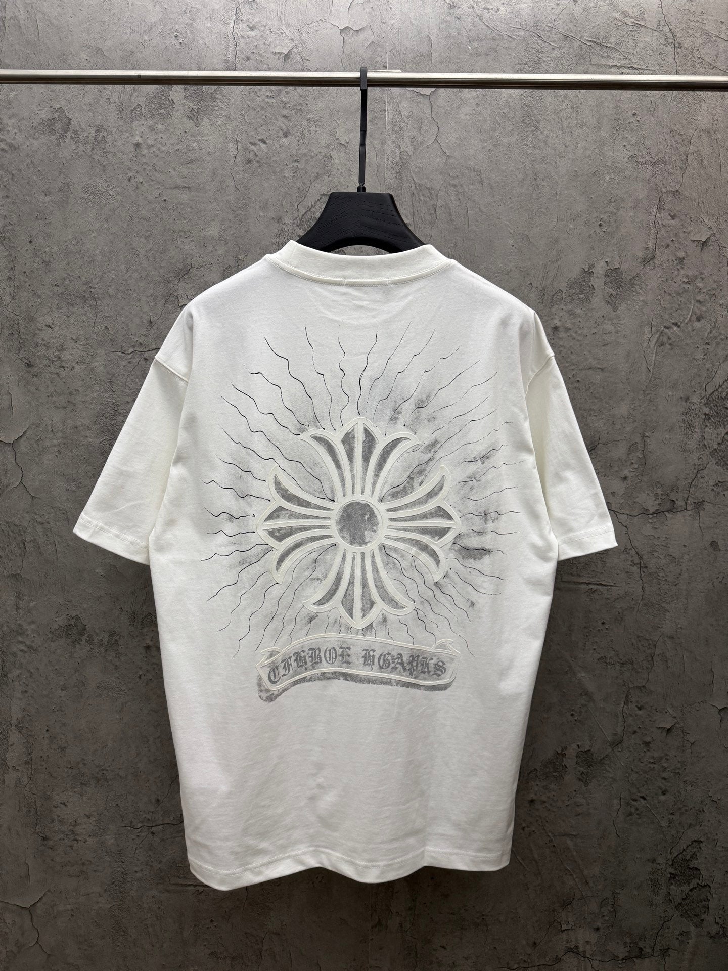 White short-sleeve T-shirt with large back sunburst floral print and banner text