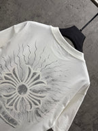 White short-sleeve T-shirt close-up of large sunburst floral graphic on the back