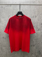 Red graphic T-shirt with crew neck, short sleeves, and small chest emblem