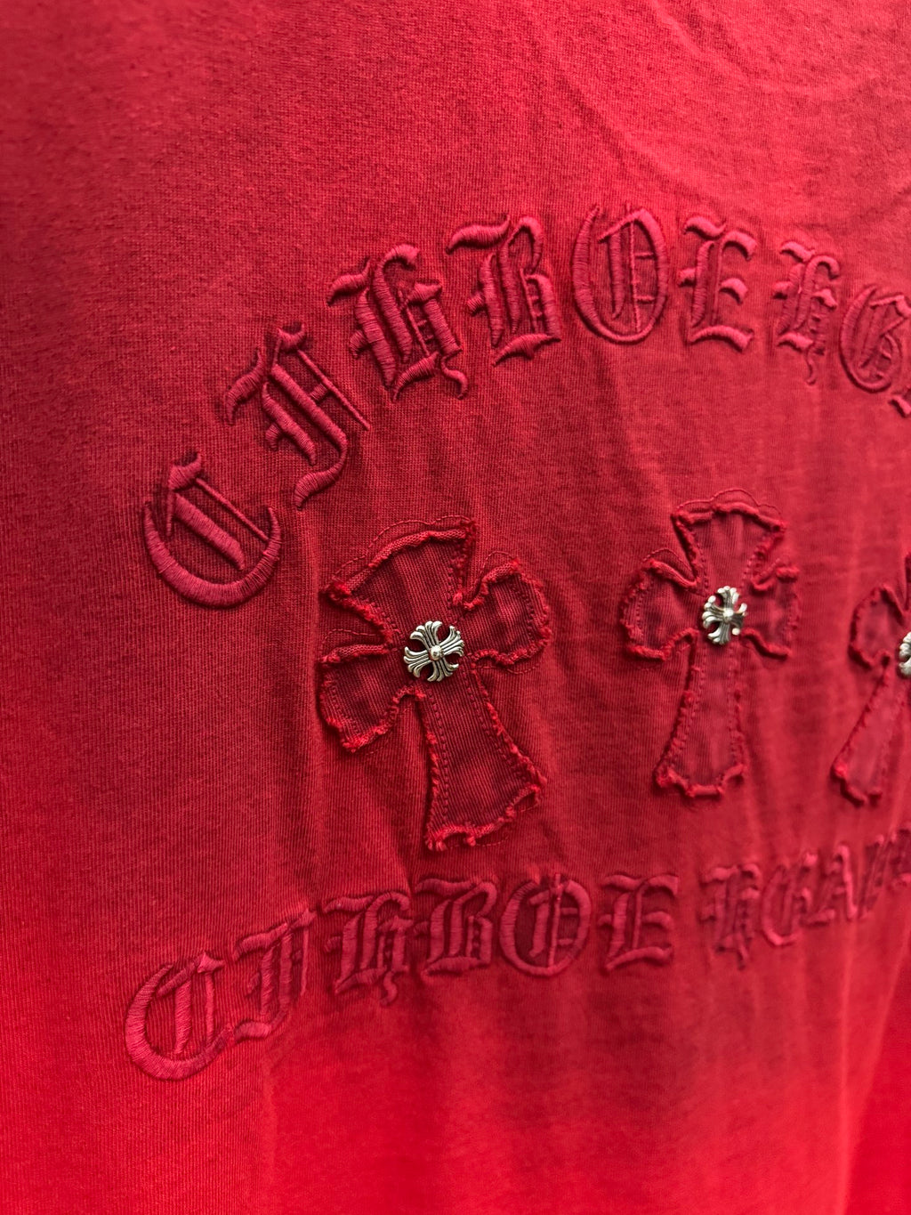 Red T-shirt close-up of back graphic with rhinestone flowers and raised embroidery