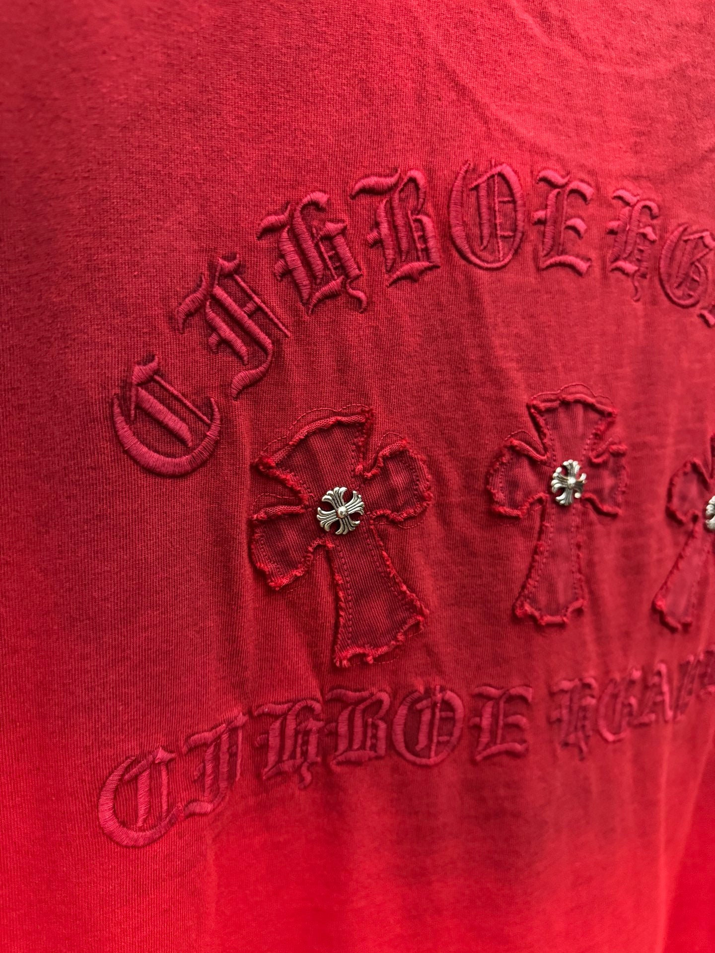 Red T-shirt close-up of back graphic with rhinestone flowers and raised embroidery