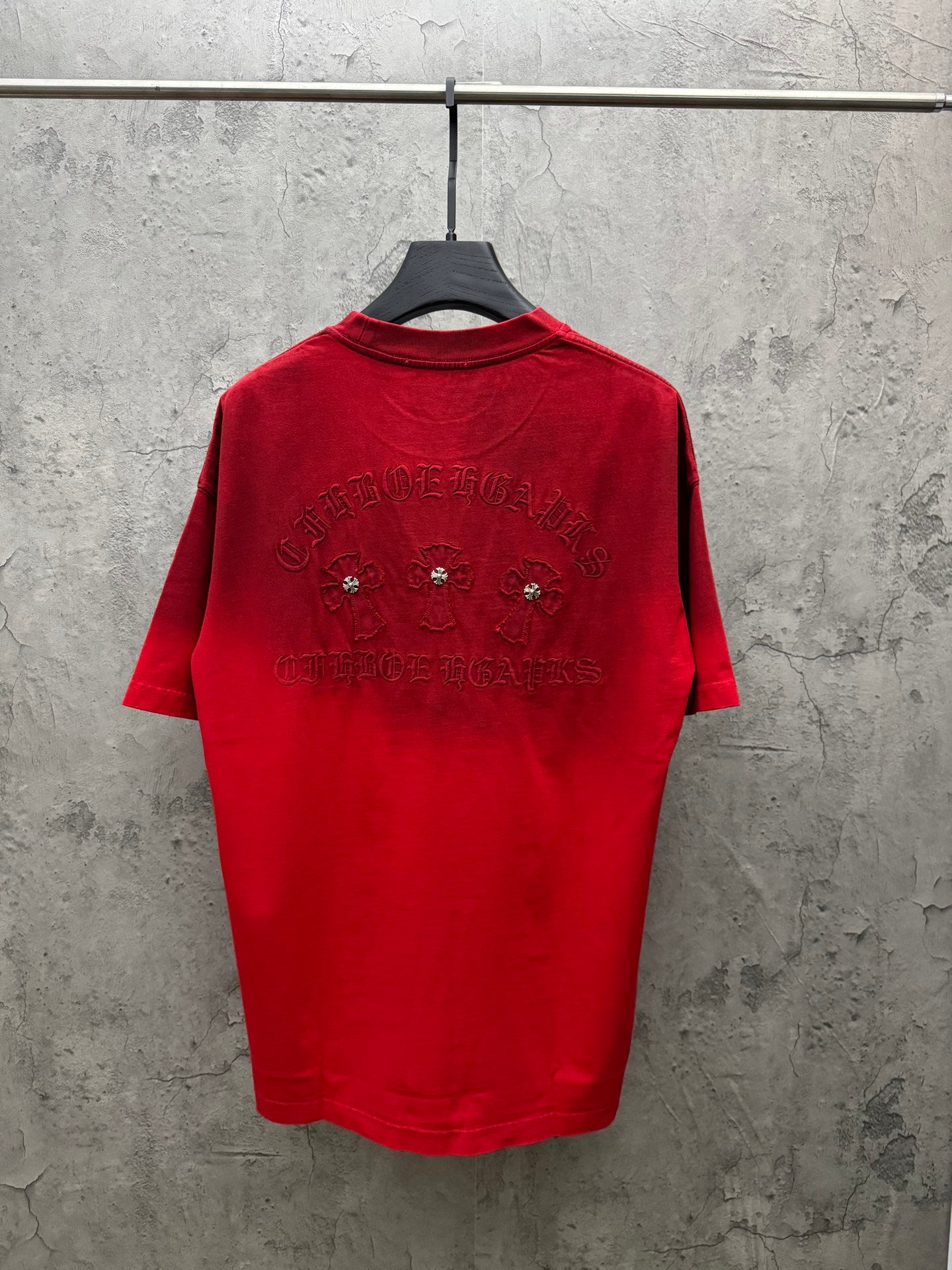 Red graphic T-shirt on hanger, with back jeweled and embroidered lettering