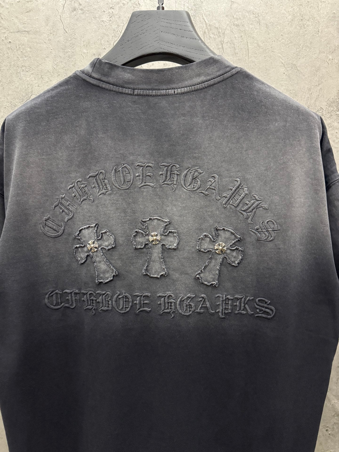 Dark gray crew-neck T-shirt with large raised back logo graphic