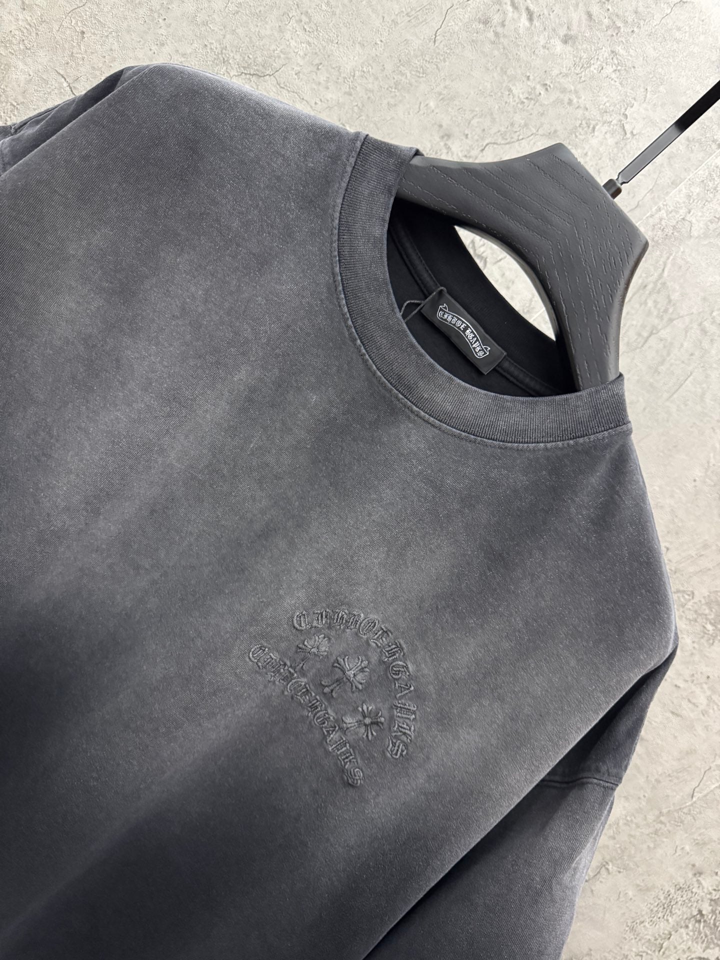 Dark gray crew-neck T-shirt neckline with interior tag