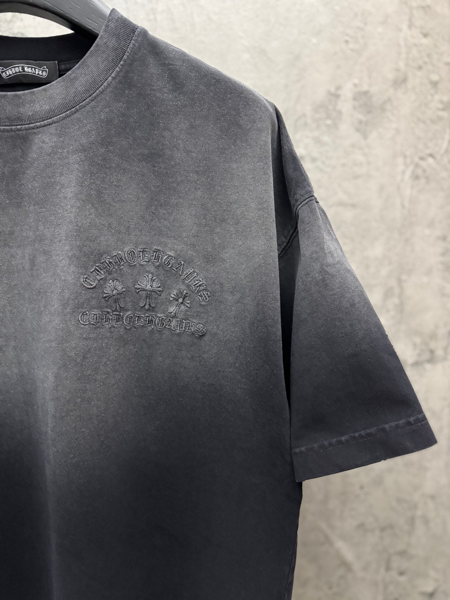 Dark gray T-shirt with small raised chest logo graphic