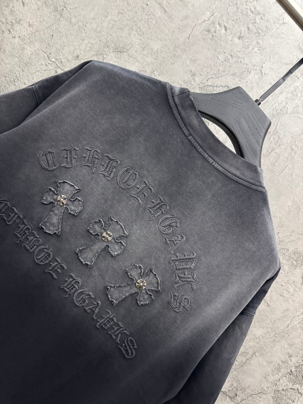 Dark gray T-shirt with raised back graphic and small emblem details