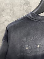Dark gray T-shirt shoulder and upper back with raised logo graphic