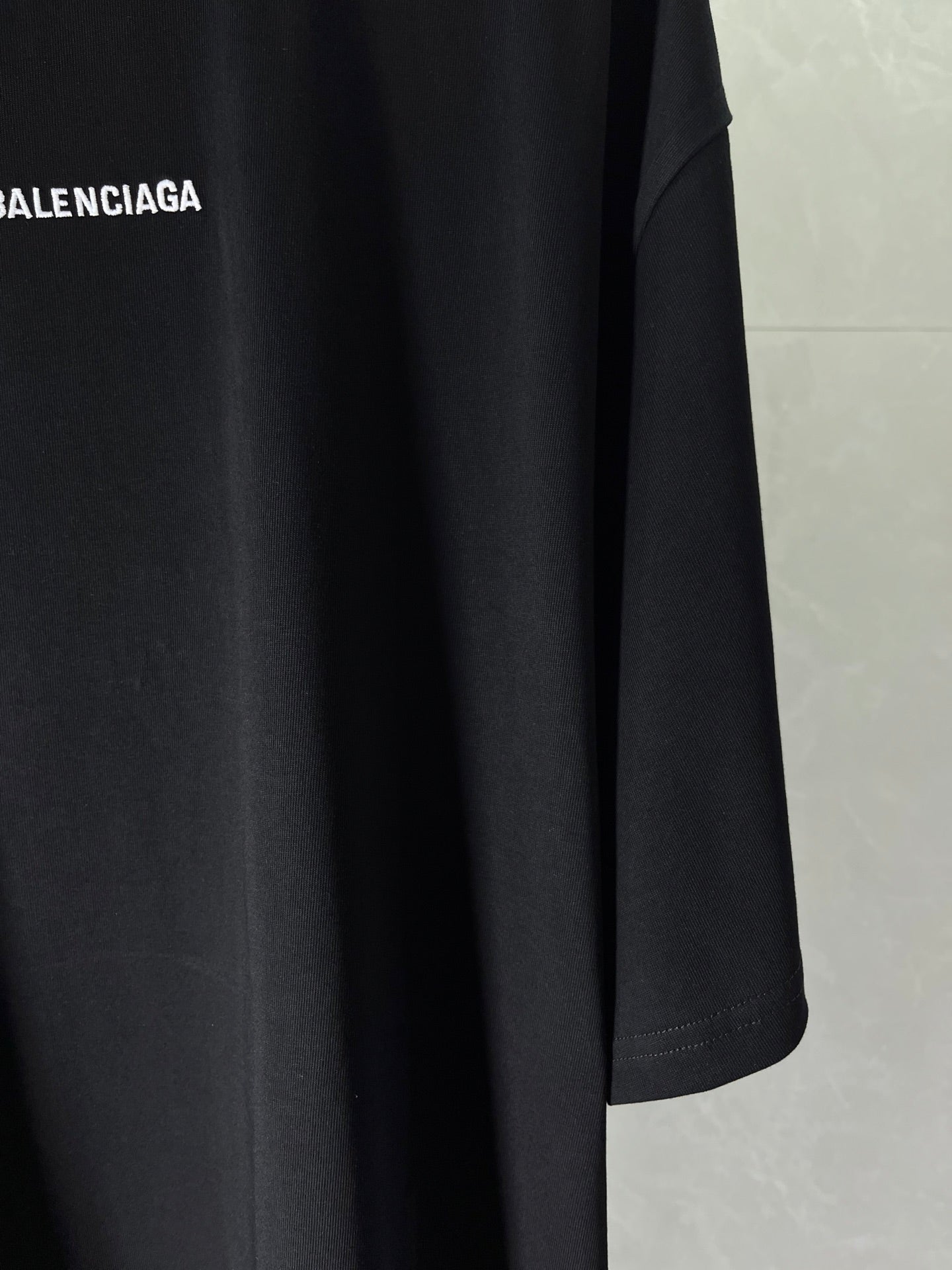 Balenciaga dark navy T-shirt sleeve and hem detail, smooth fabric drape