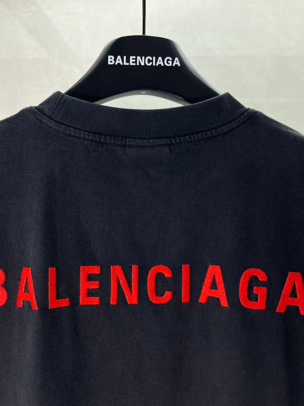 Balenciaga dark T-shirt with partial red BALENCIAGA lettering at back