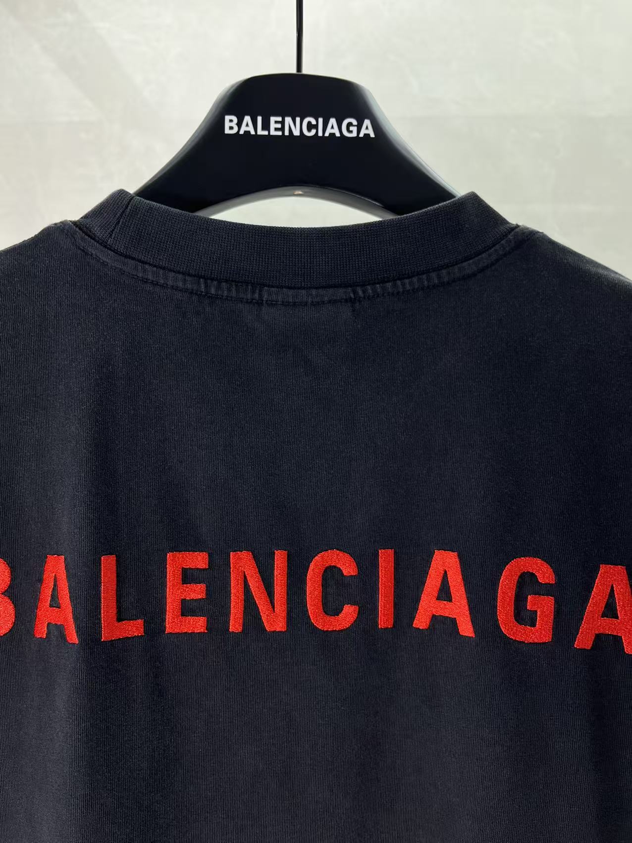 Balenciaga dark T-shirt with partial red BALENCIAGA lettering at back