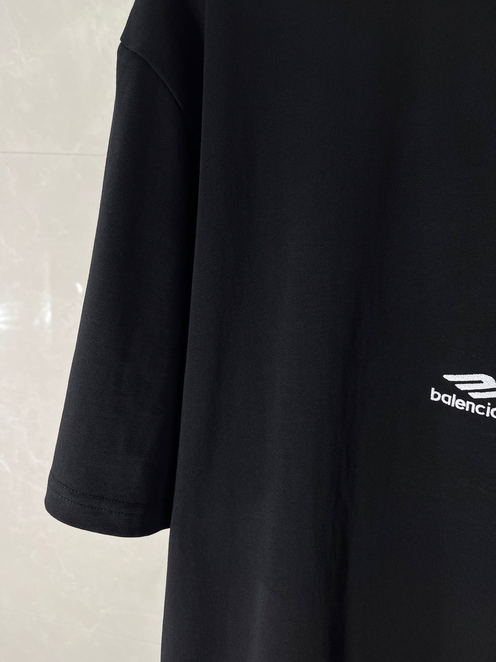 Black Balenciaga T-shirt sleeve with small logo at hem