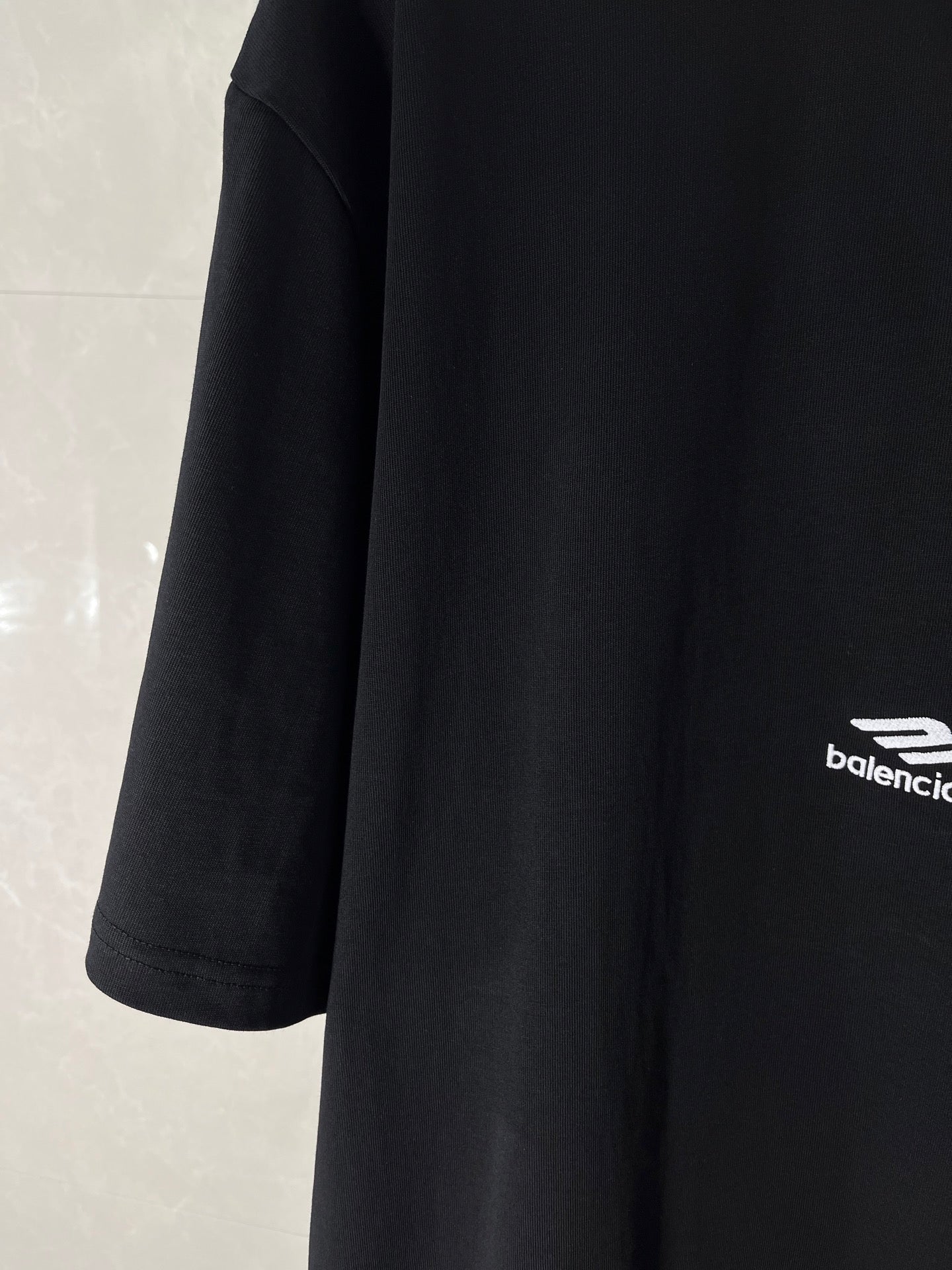 Black Balenciaga T-shirt sleeve with small logo at hem