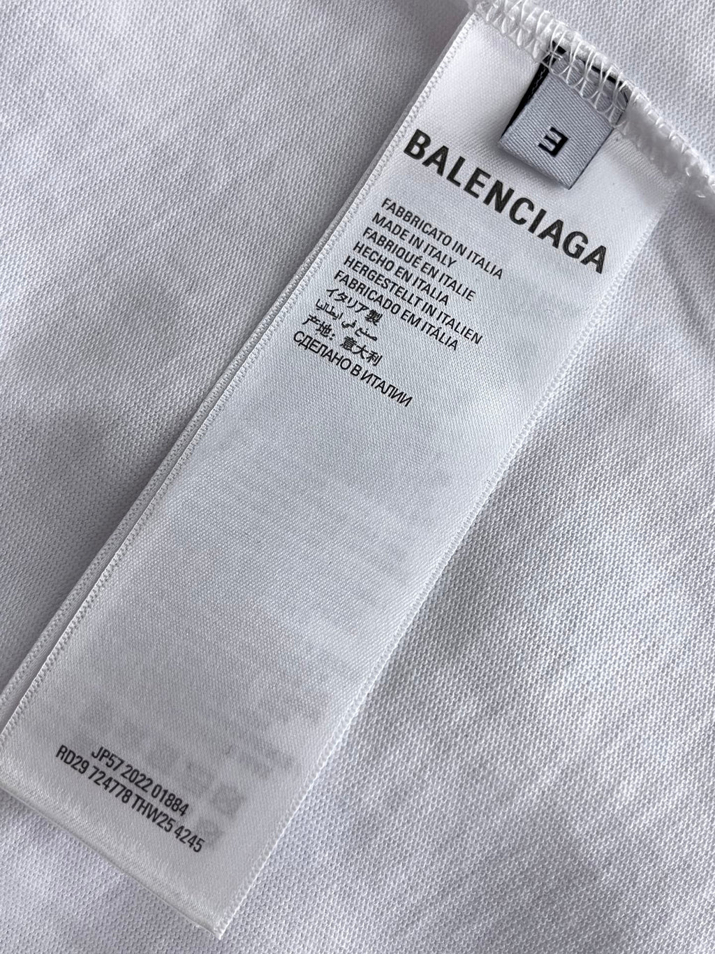Balenciaga T-shirt size label and care tag on white fabric