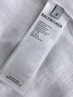 Balenciaga T-shirt size label and care tag on white fabric