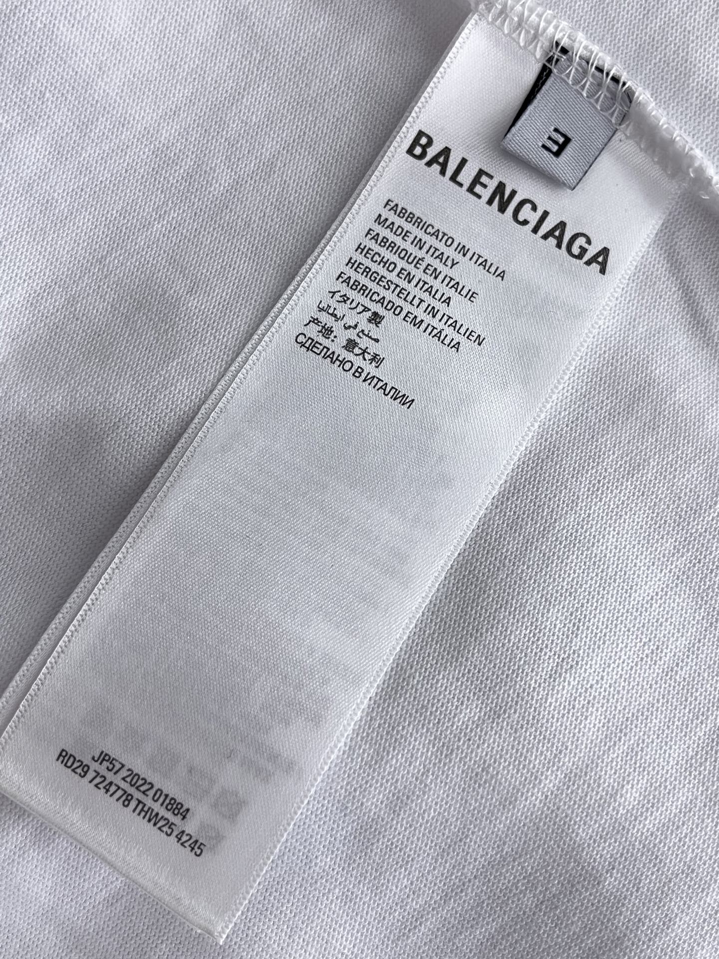 Balenciaga T-shirt size label and care tag on white fabric