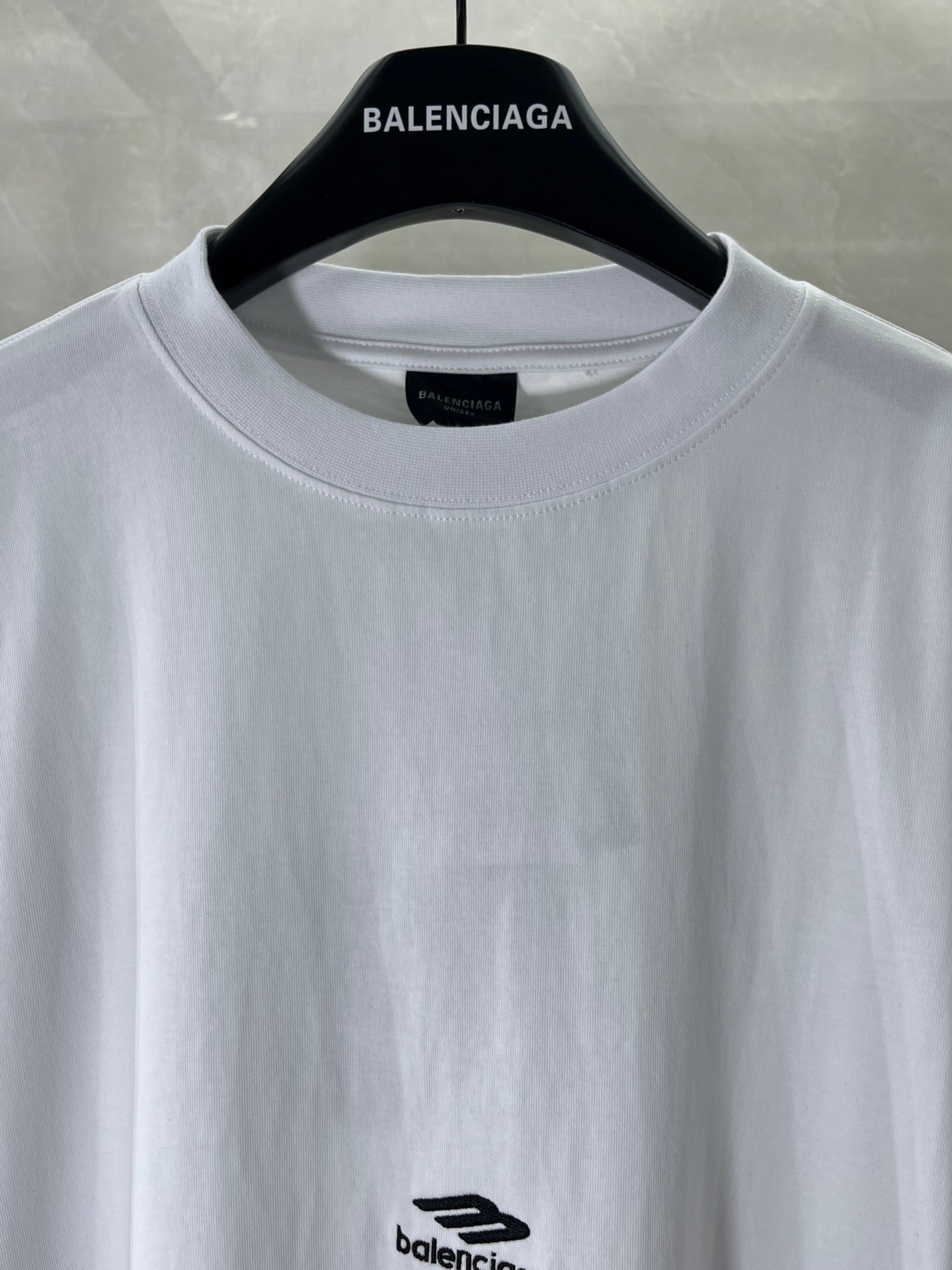 Balenciaga white T-shirt neckline close-up with small chest logo